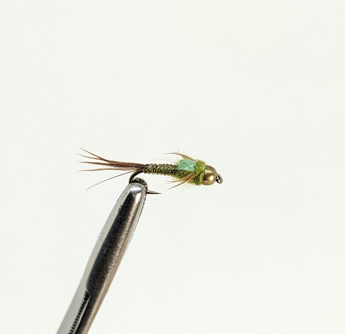 Nymphomaniac Bead Head Olive Fly fishing fly. Dry, subsurface and nymph flies for anglers and fisherman. All the flies you need for sale online. Flies to buy online. Online fly fishing supplies. Catch fish with flies from Frontier Flies.
